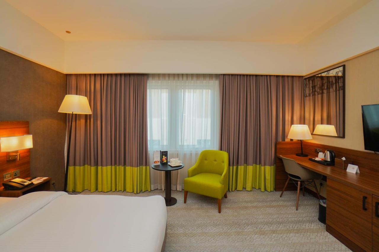 The Grand Lux Hotel ドーハ エクステリア 写真 A room at the hotel