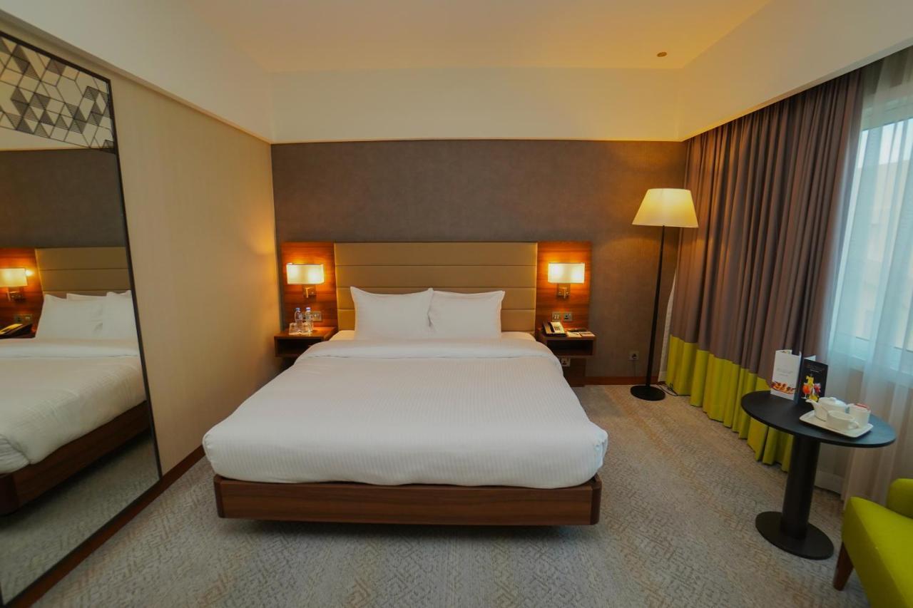 The Grand Lux Hotel ドーハ エクステリア 写真 A room at the hotel